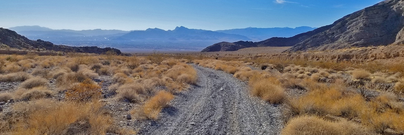 View Down Pass Into North Las Vegas. 3-6-Inch Deep Gravel Slows Mountain Bike to a Walk | Gass Peak Road Circuit | Desert National Wildlife Refuge | Nevada