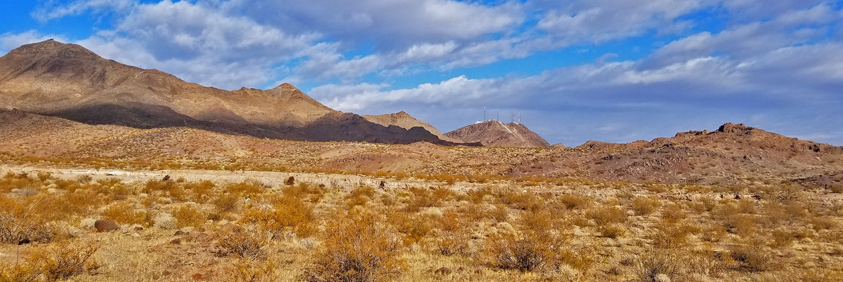 View Back Toward the Trailhead Marked by Communication Towers | McCullough Hills Trail in Sloan Canyon National Conservation Area, Nevada
