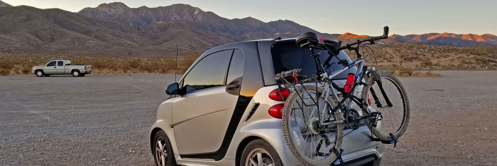 The Bike is About the Same Size as the Car! Kyle Canyon & Harris Springs Rd, La Madre Mt Destination in Background | La Madre Mountain,, El Padre Mountain, Burnt Peak | La Madre Mountains Wilderness, Nevada