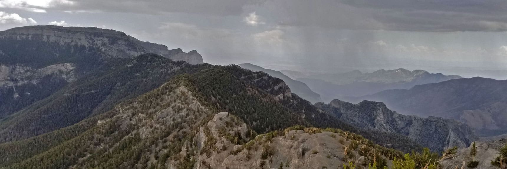 Rain Streaming from the Clouds on the Horizon Viewed Down Kyle Canyon from Lee Peak Summit. | Lee Peak Summit via Lee Canyon Mid Ridge | Mt. Charleston Wilderness | Spring Mountains, Nevada