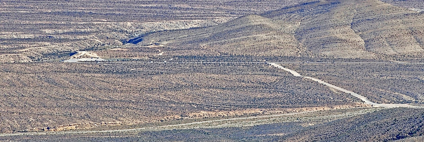 Larger View of Straight Rd Ending at Kyle Canyon Rd. Car Parked in Graveled Area to Left | Kyle Canyon Grand Crossing | Northern Half | La Madre Mountains Wilderness, Nevada