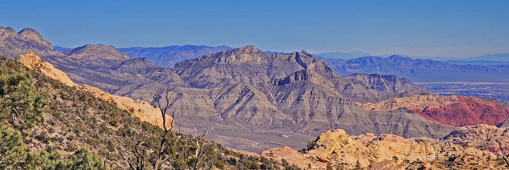Damsel Peak and Distant Muddy Mountains Frame Red Rock Canyon. | Mid Upper Crest Ridgeline | Rainbow Mountain Wilderness, Nevada
