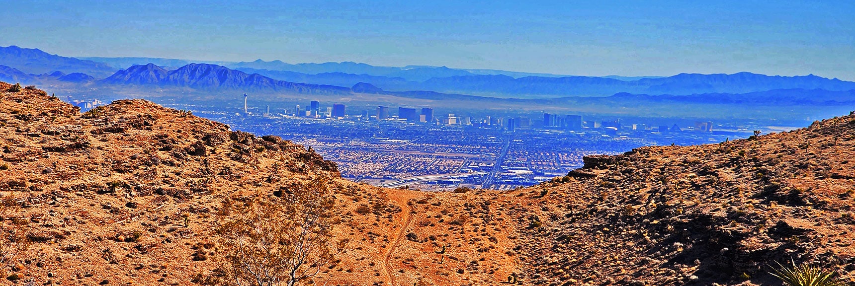 Vegas Strip Through Opening. Overlook Ridge Trail Heads South (Right) | Eastern Outer Circuit | Blue Diamond Hill | Red Rock Canyon, Nevada
