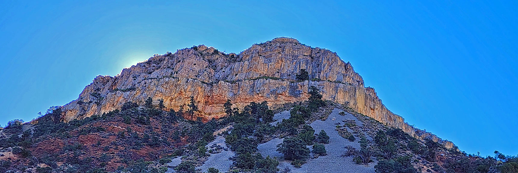 Northern Cliffs of Landmark Bluff Shield the Rising Sun. | Landmark Bluff Circuit | Lovell Canyon, Nevada