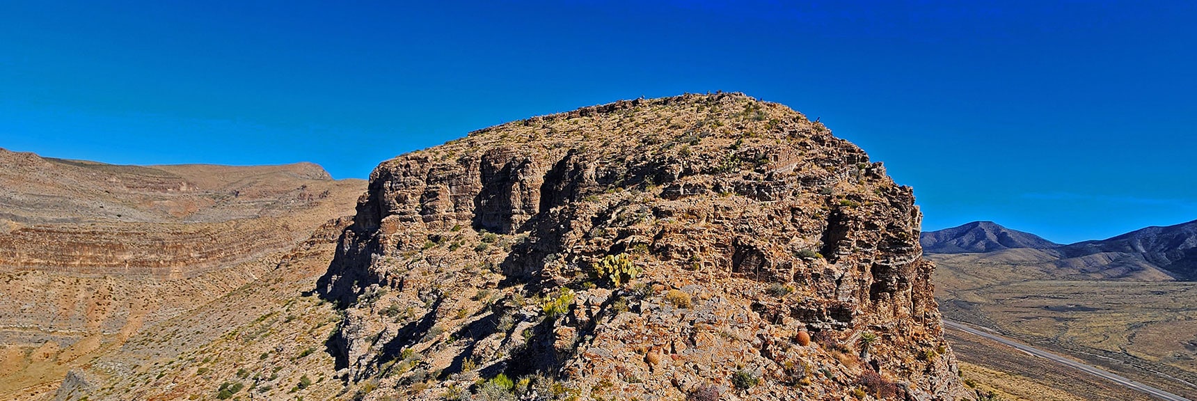 Next Stretch of Ridgeline Guarded by Cliffs. Potential Passage Along Left Cliff Base. | Landmark Bluff | Lovell Canyon, Nevada