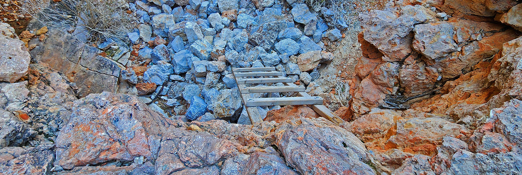 Venture Over the Edge of the Dry Fall Barrier Aided by a Small Wooden Ladder. | Fossil Canyon | Cowboy Canyon | Blue Diamond Hill, Nevada